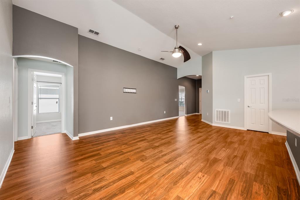 1355 Windward Oaks Loop Auburndale, FL 33823 - Photo 19 of 25 a view of empty room with wooden floor and fan