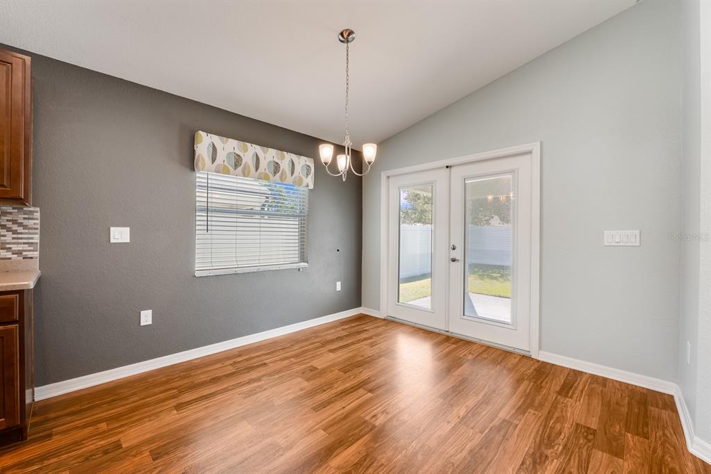 1355 Windward Oaks Loop Auburndale, FL 33823 - Photo 21 of 25 a view of an empty room with window and wooden floor