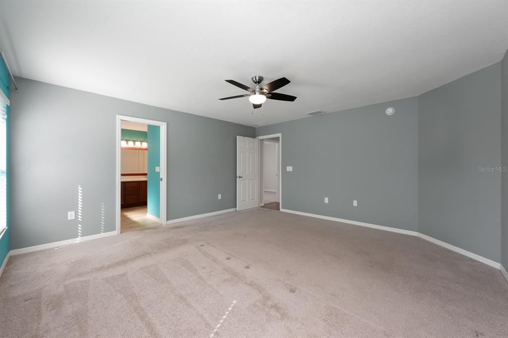 1355 Windward Oaks Loop Auburndale, FL 33823 - Photo 23 of 25 a view of an empty room with a ceiling fan