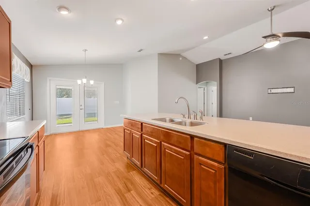 a spacious bathroom with a granite countertop sink a large mirror and shower