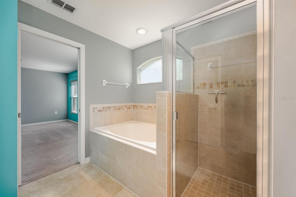 1355 Windward Oaks Loop Auburndale, FL 33823 - Photo 9 of 25 a bathroom with a bathtub and a shower