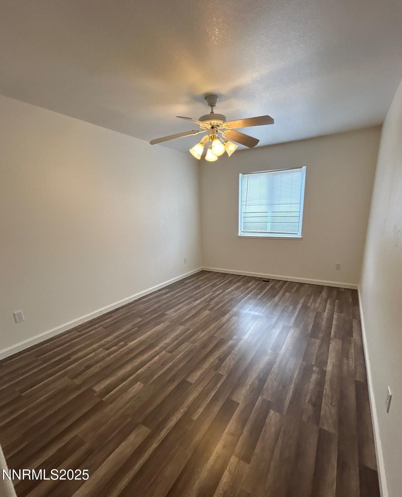 7470 Rodin Court Sun Valley, NV 89433 - Photo 13 of 23 wooden floor in an empty room with a window