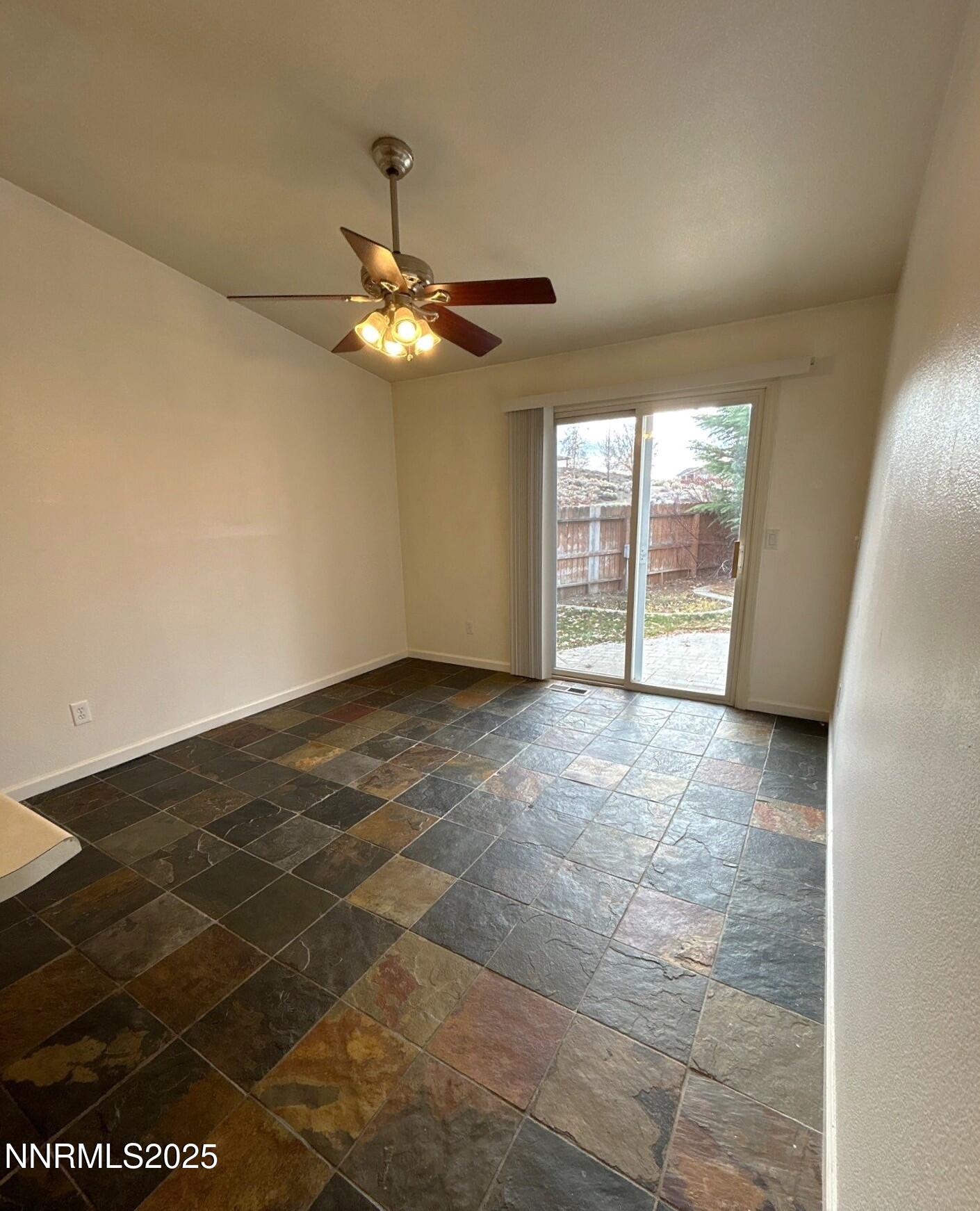 7470 Rodin Court Sun Valley, NV 89433 - Photo 7 of 23 a view of an empty room with glass door