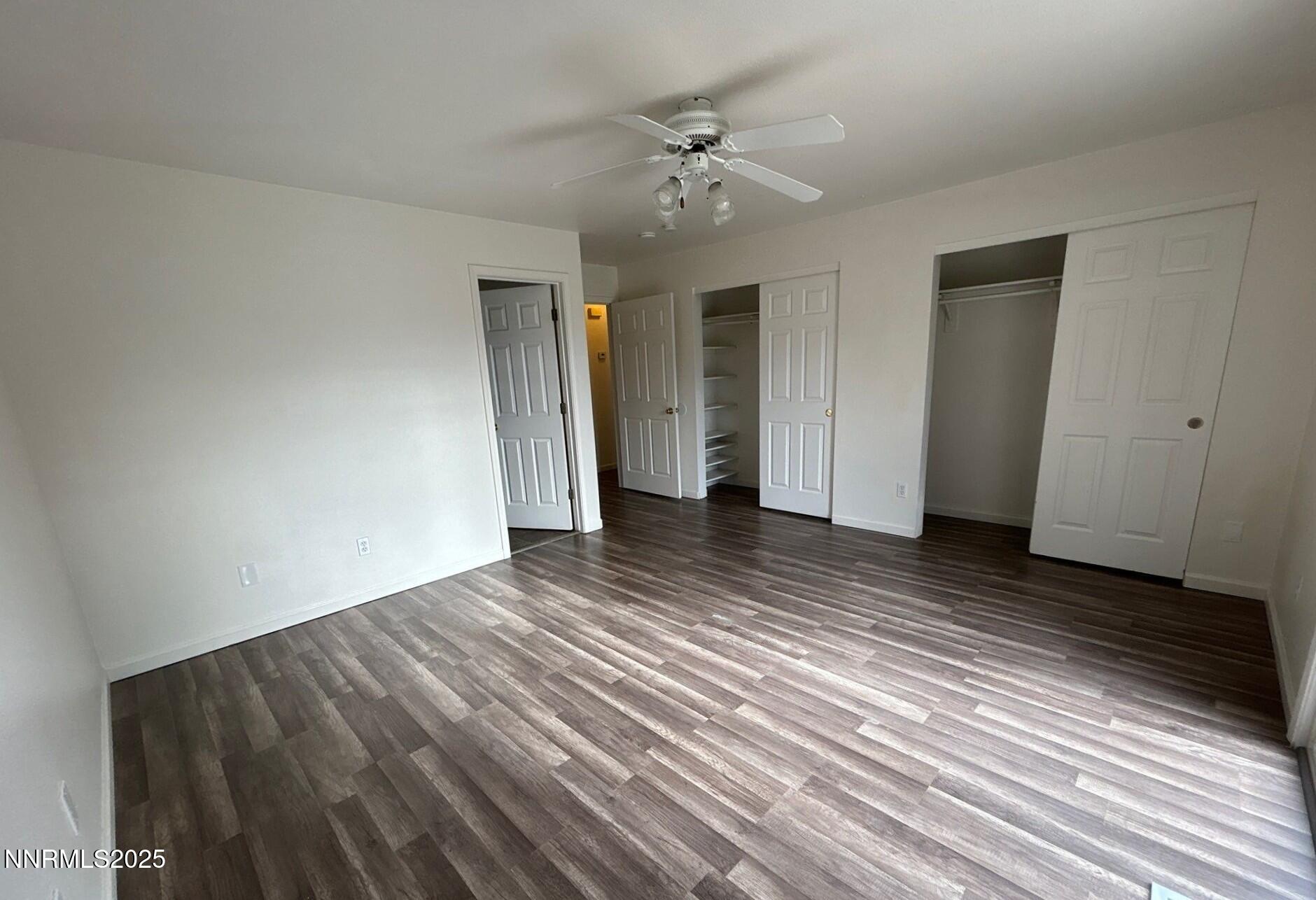 7470 Rodin Court Sun Valley, NV 89433 - Photo 8 of 23 a view of a livingroom with wooden floor and a ceiling fan