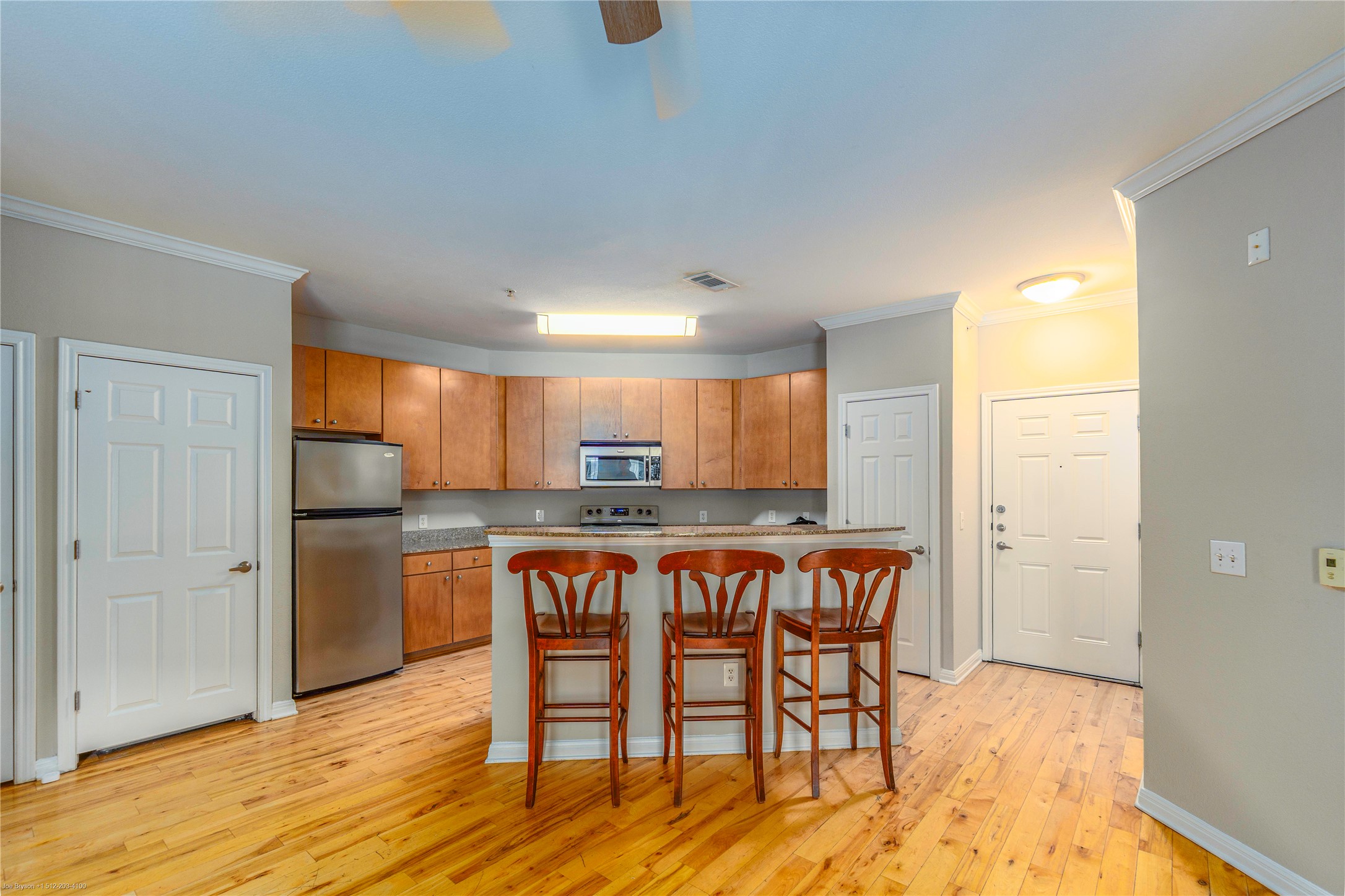 2502 Leon Street, Unit 305 Austin, TX 78705 - Photo 2 of 26 Entry (on right) into condo. Large kitchen with granite island and breakfast bar.