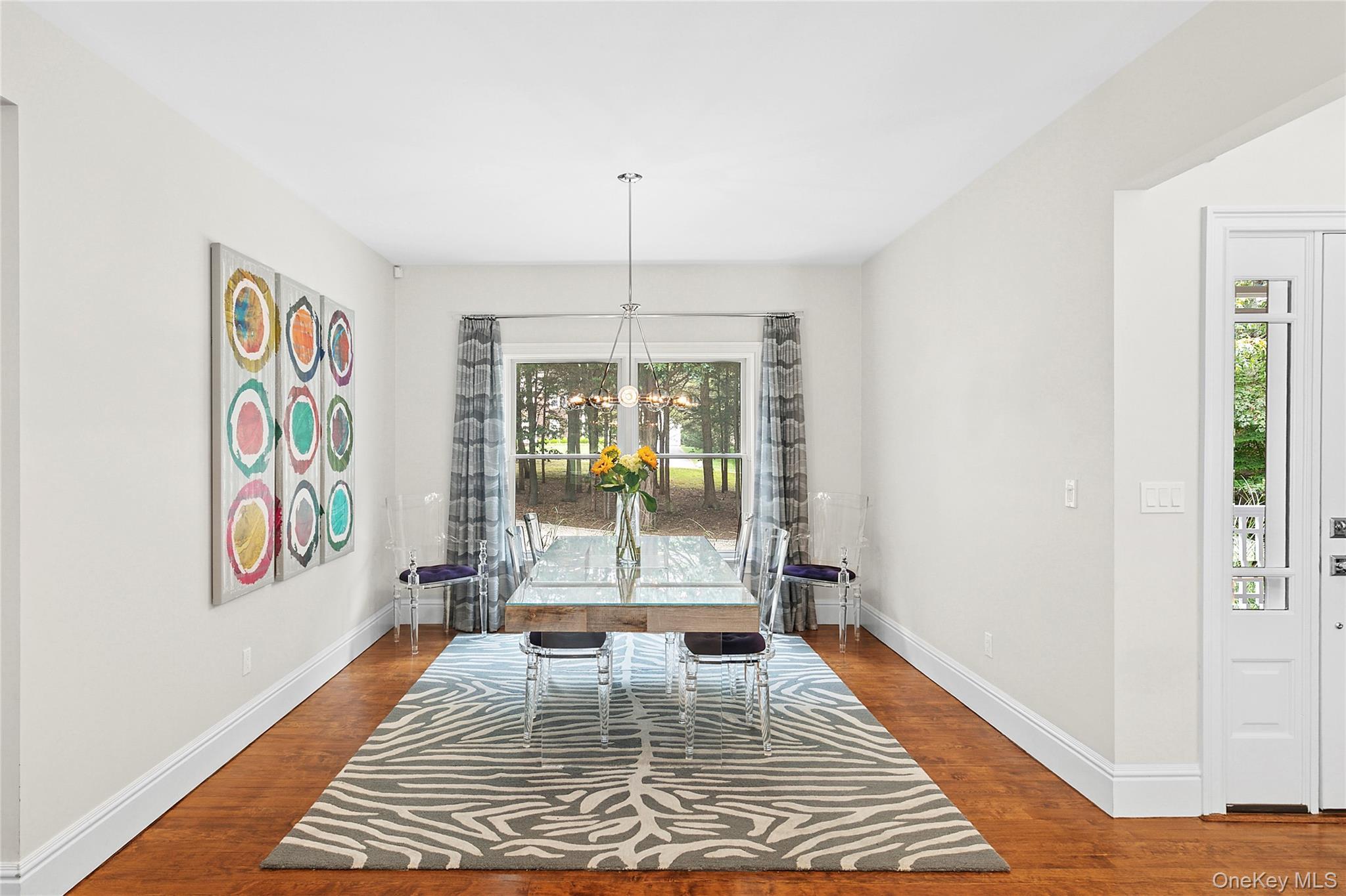 3470 North Bayview Road Southold, NY 11971 - Photo 5 of 25 Dining space featuring wood floors and a chandelier
