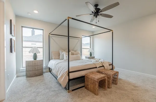 a bedroom with a bed window and a ceiling fan