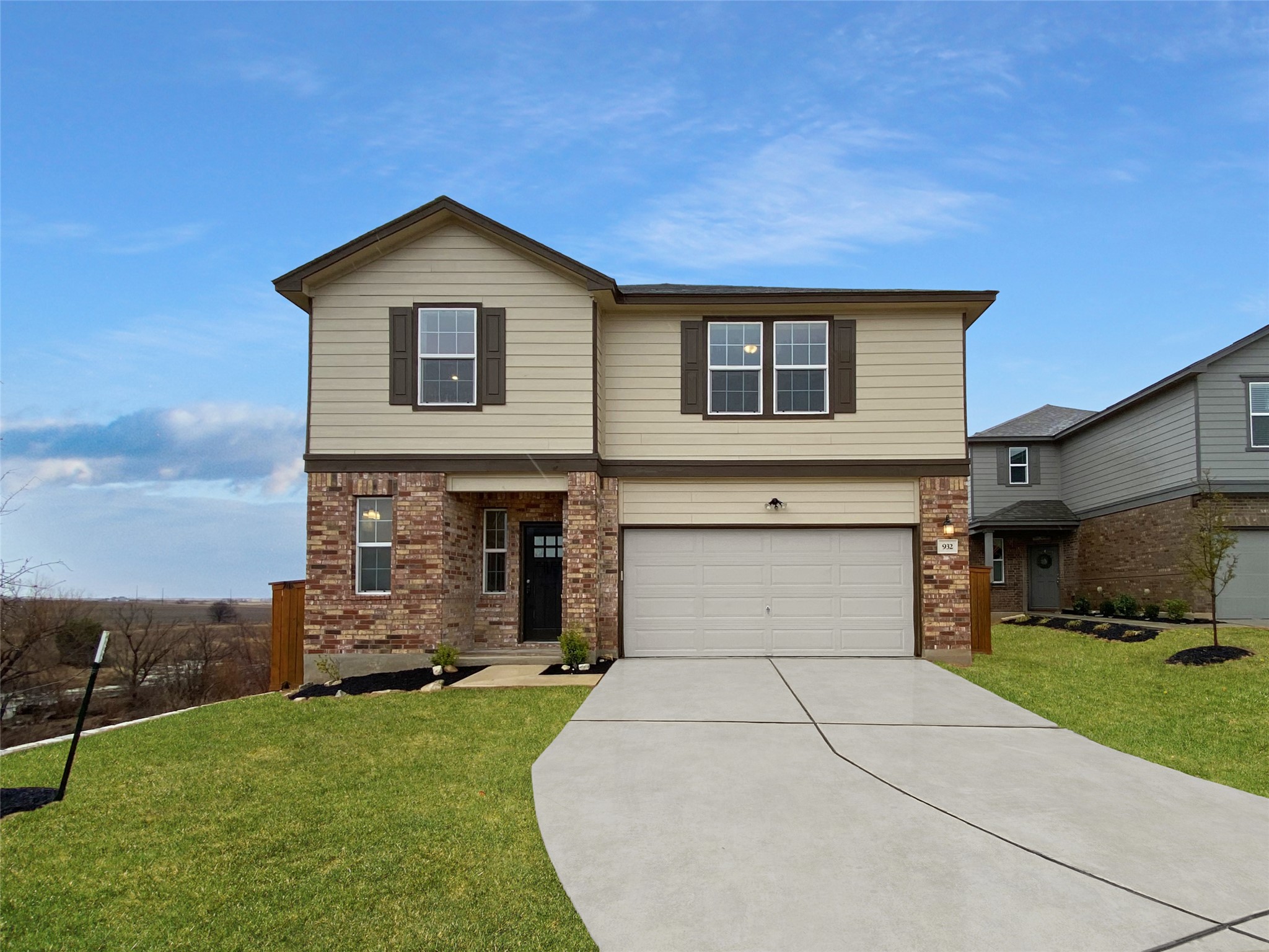 932 Yellow Ribbon Trail Jarrell, TX 76537 - Photo 1 of 26 a front view of a house with a garden