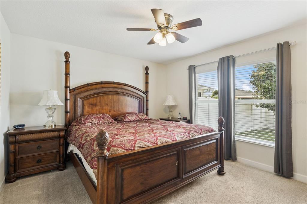 3342 Raleigh Drive Winter Haven, FL 33884 - Photo 15 of 50 a bedroom with a bed and a chandelier