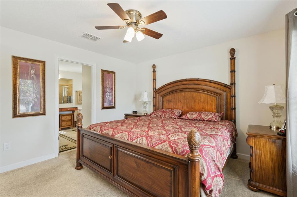 3342 Raleigh Drive Winter Haven, FL 33884 - Photo 16 of 50 a bedroom with a bed and a chandelier
