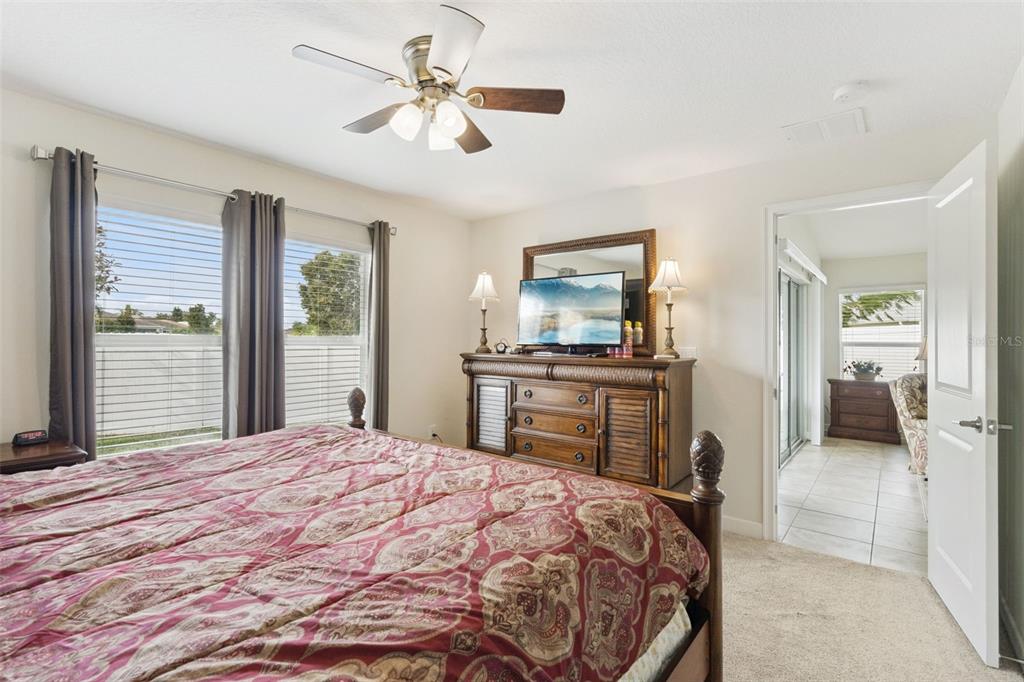 3342 Raleigh Drive Winter Haven, FL 33884 - Photo 17 of 50 a bedroom with a bed a dresser and a chandelier