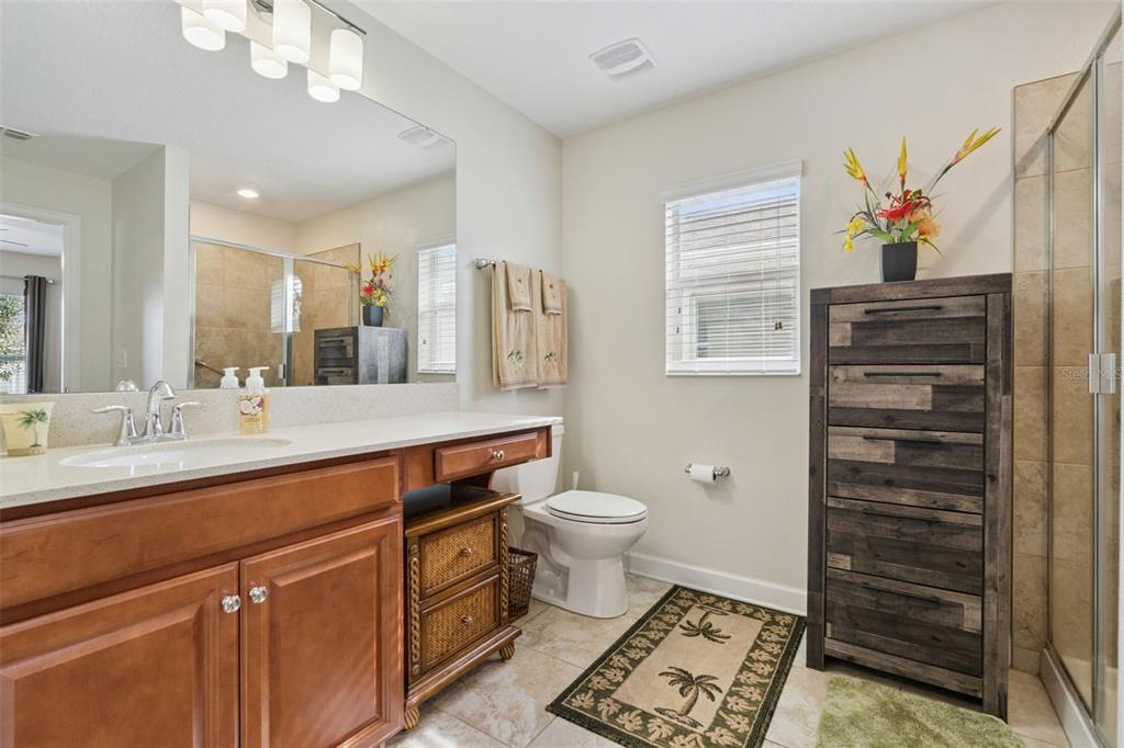 3342 Raleigh Drive Winter Haven, FL 33884 - Photo 18 of 50 a spacious bathroom with a sink a toilet and a mirror