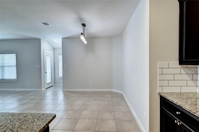 an empty room with furniture and a window