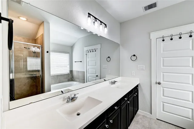 a bathroom with bathtub and window