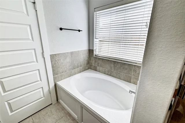 a view of room with a ceiling fan and window