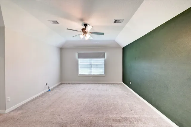 a view of a big room with chandelier fan and windows