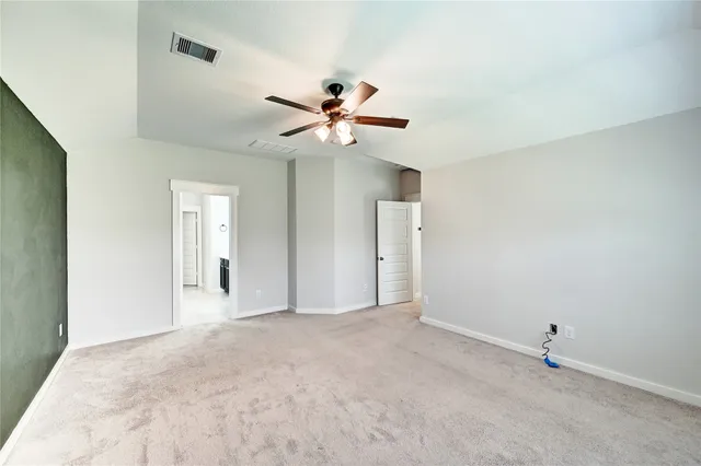 a view of a backyard with plants and wooden fence