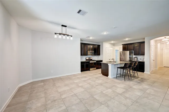 a kitchen with a refrigerator and a microwave