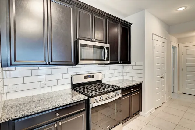a kitchen with granite countertop stainless steel appliances and cabinets