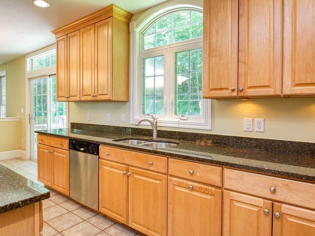 126 Walnut Street Shrewsbury, MA 01545 - Photo 11 of 41 a kitchen with granite countertop white cabinets and a window