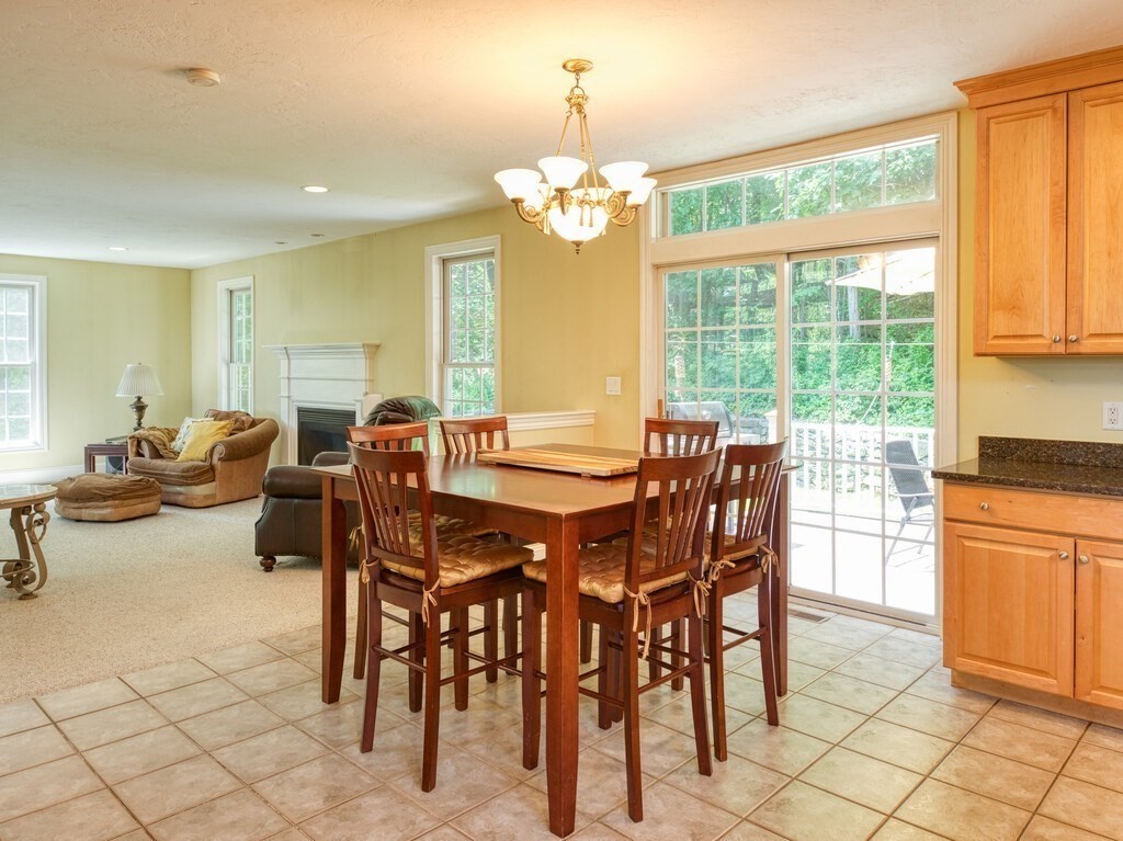 126 Walnut Street Shrewsbury, MA 01545 - Photo 15 of 41 a view of a dining room with furniture a chandelier and large windows