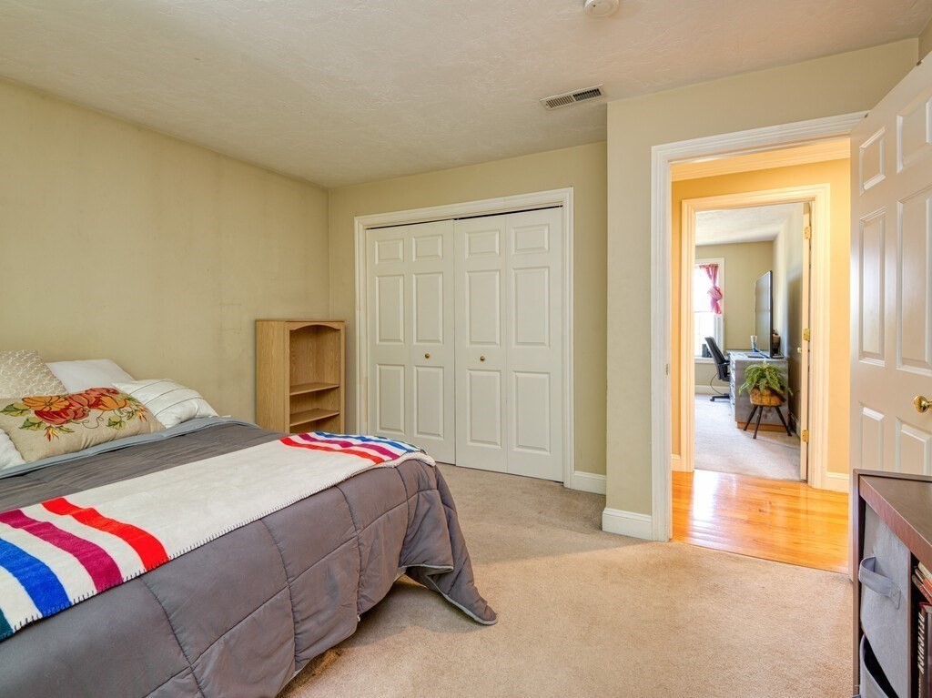 126 Walnut Street Shrewsbury, MA 01545 - Photo 29 of 41 a bedroom with a bed and a couch