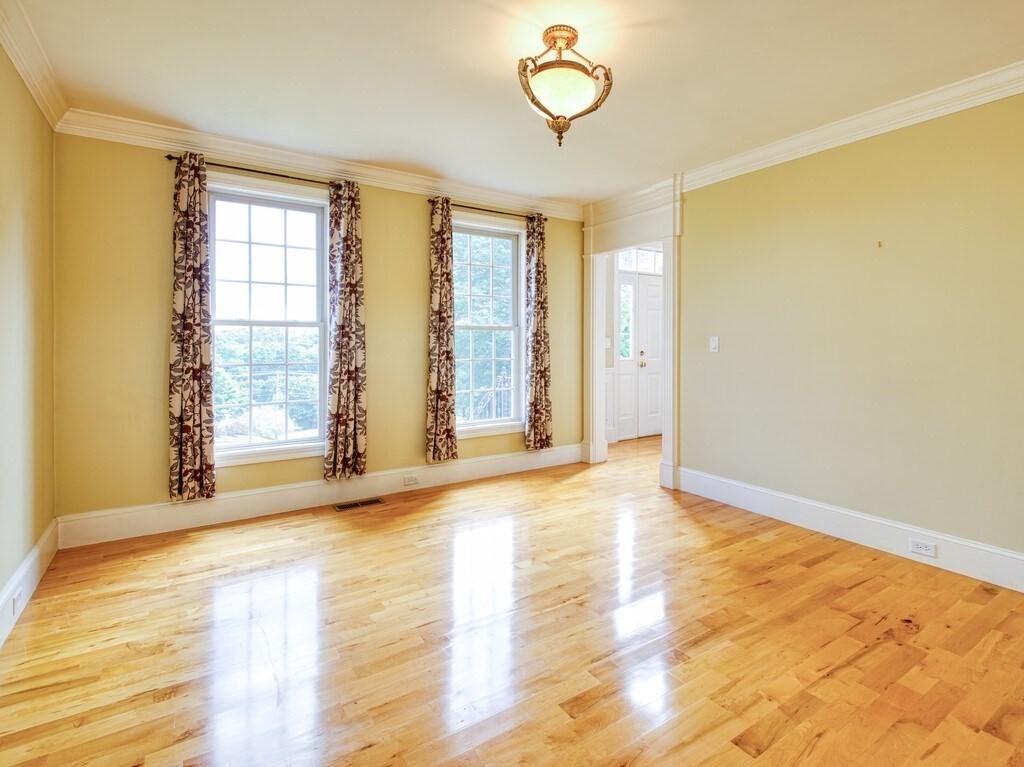 126 Walnut Street Shrewsbury, MA 01545 - Photo 5 of 41 a view of an empty room with wooden floor and a window