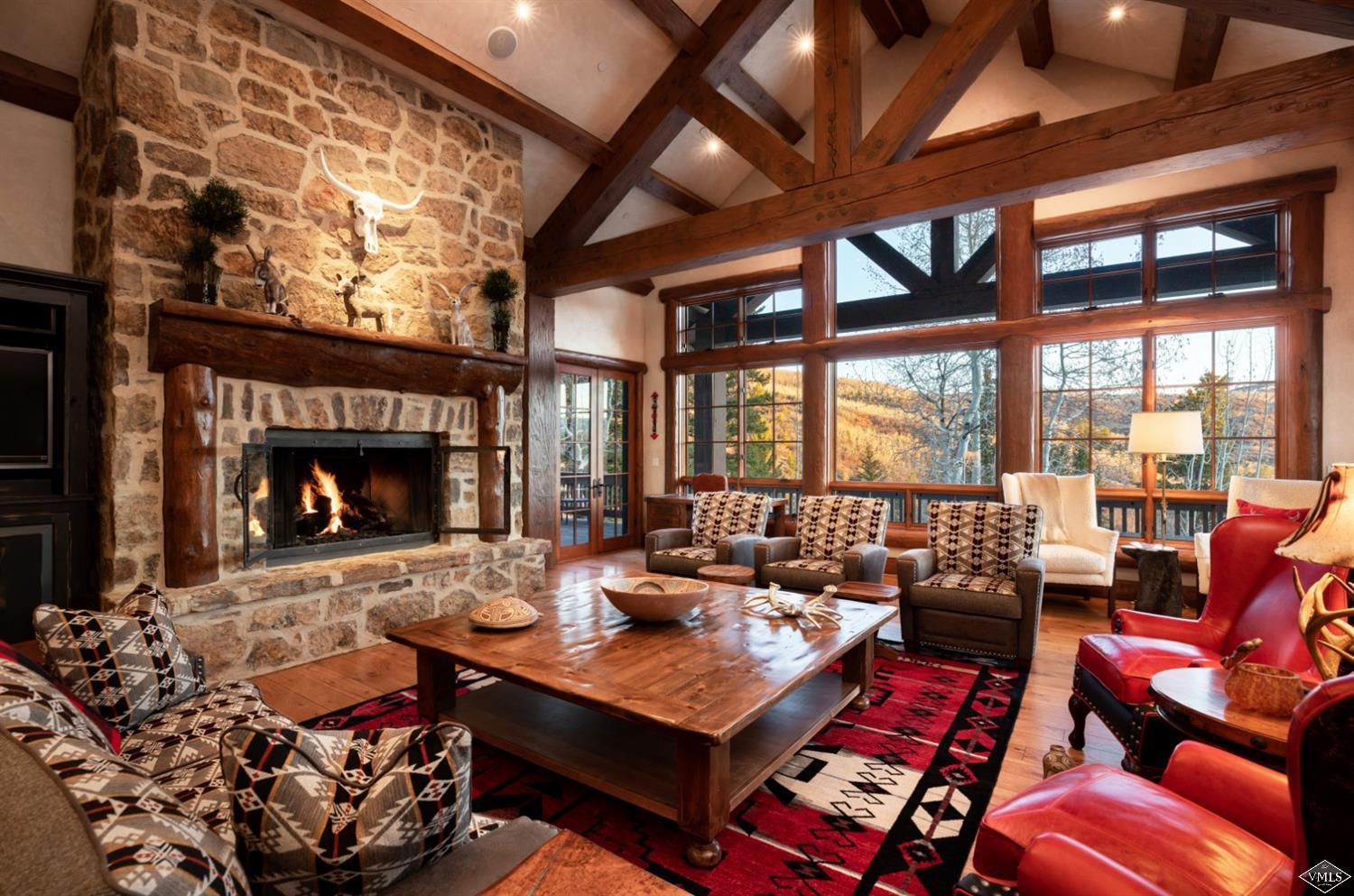 a living room with furniture a fireplace and a large window