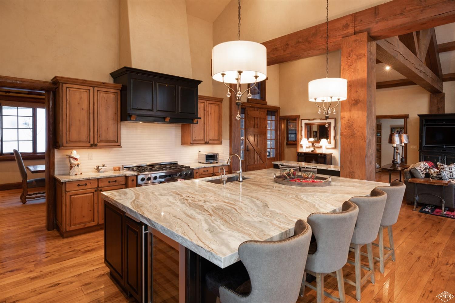 303 Graham Road Edwards, CO 81632 - Photo 2 of 13 a kitchen with stainless steel appliances granite countertop a stove top oven a sink dishwasher and white cabinets with wooden floor