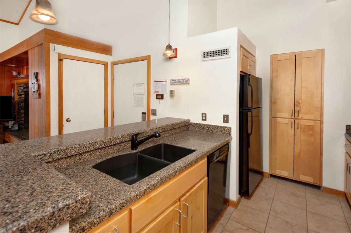 21630 Highway 6, Unit 2150 Keystone, CO 80435 - Photo 11 of 46 a kitchen with stainless steel appliances granite countertop a sink stove and refrigerator