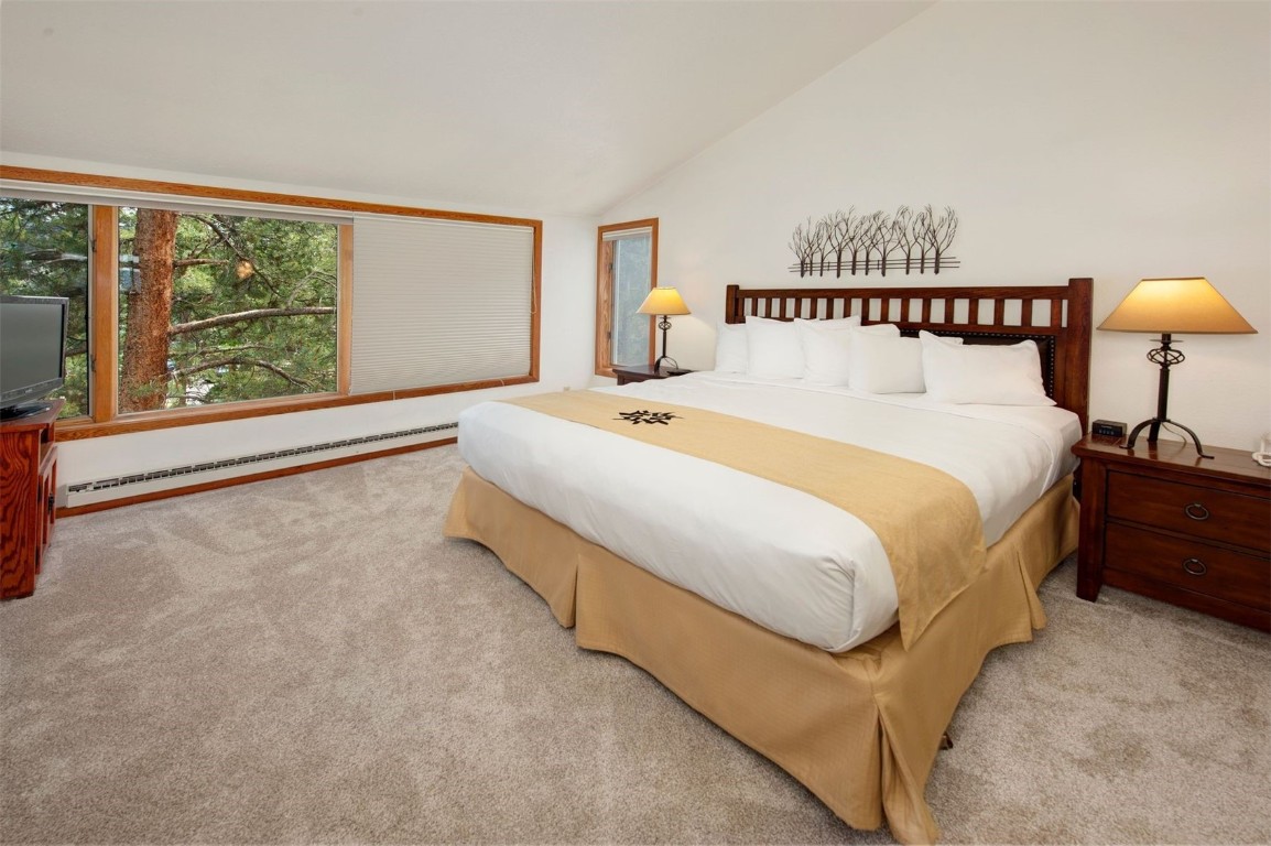 21630 Highway 6, Unit 2150 Keystone, CO 80435 - Photo 19 of 46 a spacious bedroom with a bed and a large window
