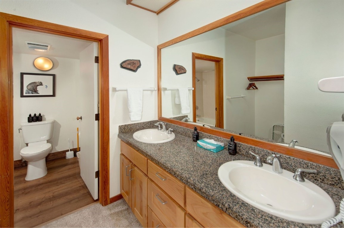21630 Highway 6, Unit 2150 Keystone, CO 80435 - Photo 23 of 46 a bathroom with a granite countertop double vanity sinks and a mirror
