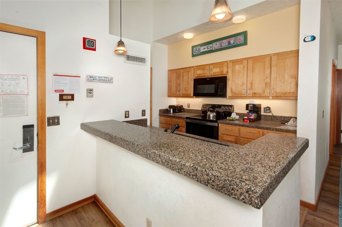 21630 Highway 6, Unit 2150 Keystone, CO 80435 - Photo 10 of 46 a kitchen with stainless steel appliances granite countertop a sink stove and refrigerator