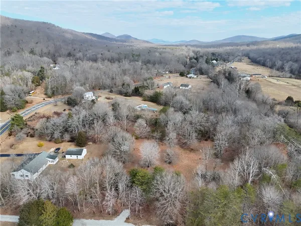 an aerial view of house with yard and mountain view