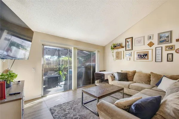 a living room with furniture and a potted plant