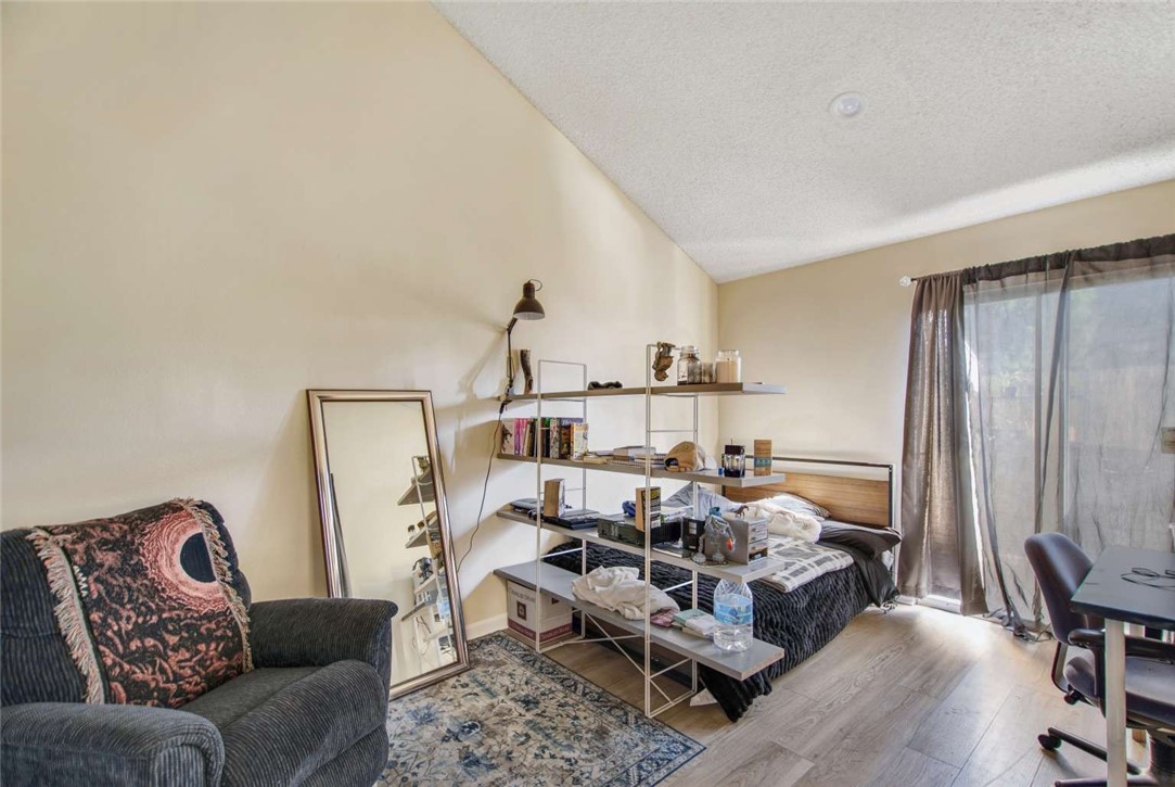 6733 Caro Street, Unit 47 Paramount, CA 90723 - Photo 11 of 25 a bed room with furniture and a large window
