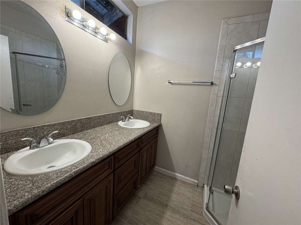 6733 Caro Street, Unit 47 Paramount, CA 90723 - Photo 18 of 25 a bathroom with a granite countertop sink and a mirror