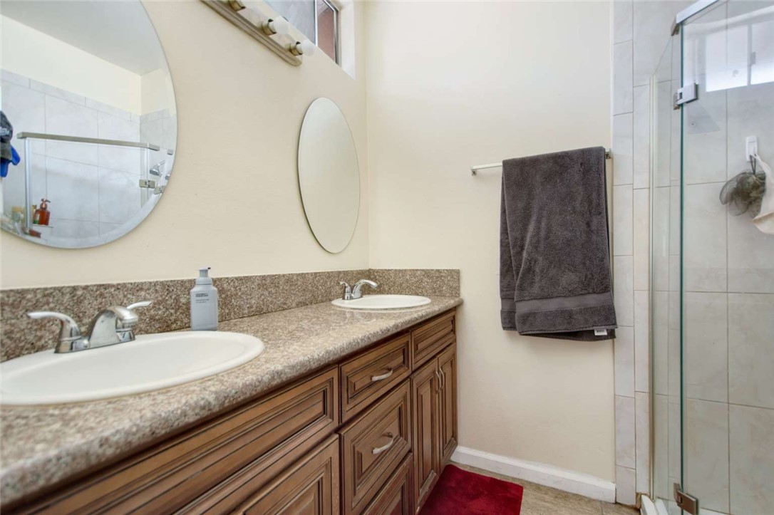 6733 Caro Street, Unit 47 Paramount, CA 90723 - Photo 4 of 25 a bathroom with a granite countertop sink and a mirror