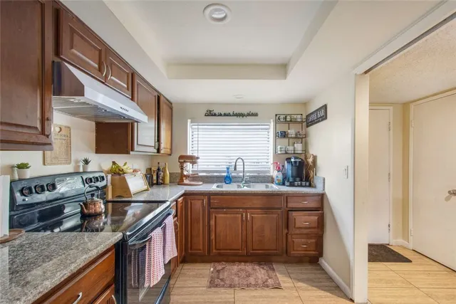 a kitchen with a sink stove and cabinets