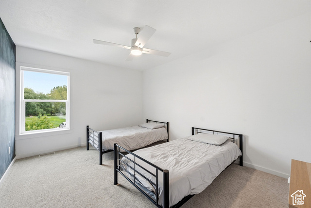 1295 North Canyon View Road Midway, UT 84049 - Photo 41 of 52 Spacious room with plush carpeting, a large window, a modern ceiling fan, and crisp white walls