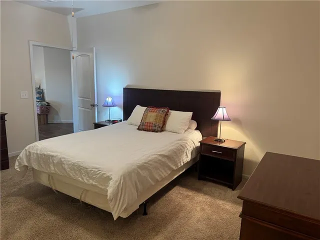 a bathroom with a granite countertop sink and a refrigerator