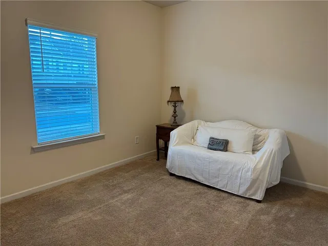 a bedroom with a bed and a night stand