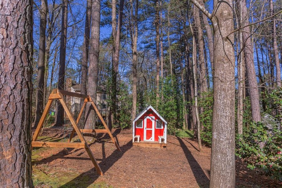7533 Milestone Court Raleigh, NC 27615 - Photo 36 of 51 Backyard with playhouse and swing