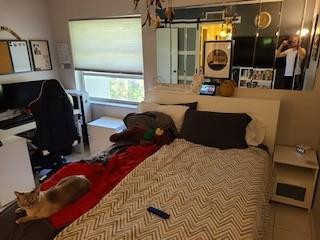 632 Northwest 13th Street Boca Raton, FL 33486 - Photo 12 of 12 a bedroom with a bed a mirror and dresser
