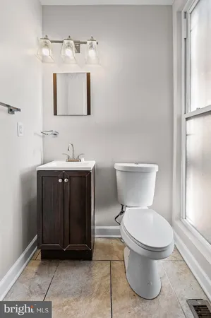 a white toilet sitting next to a bathroom sink