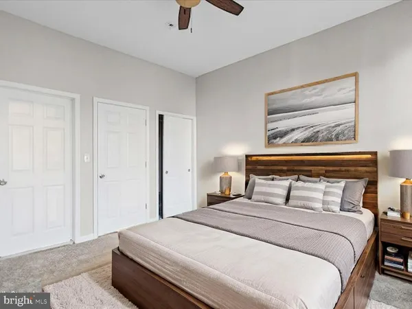 a bedroom with a bed and a painting on the wall