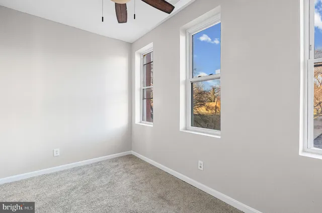 an empty room with windows and closet