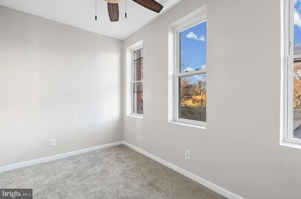 an empty room with windows and closet