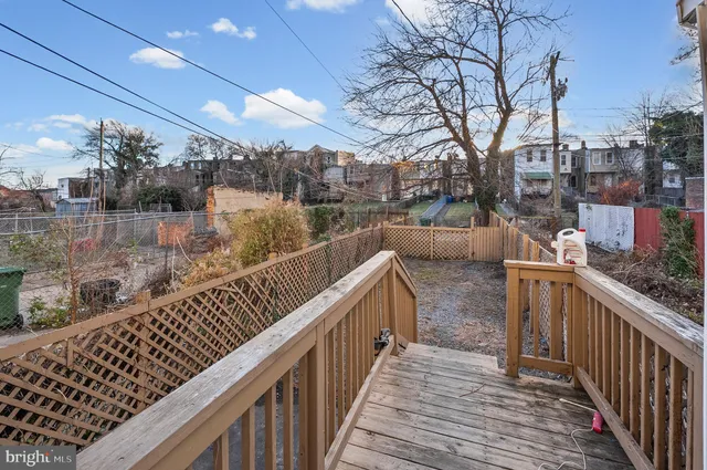 a balcony with wooden floor and lake view