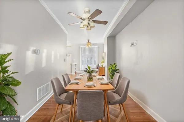 a view of a dining room with furniture wooden floor and chandelier